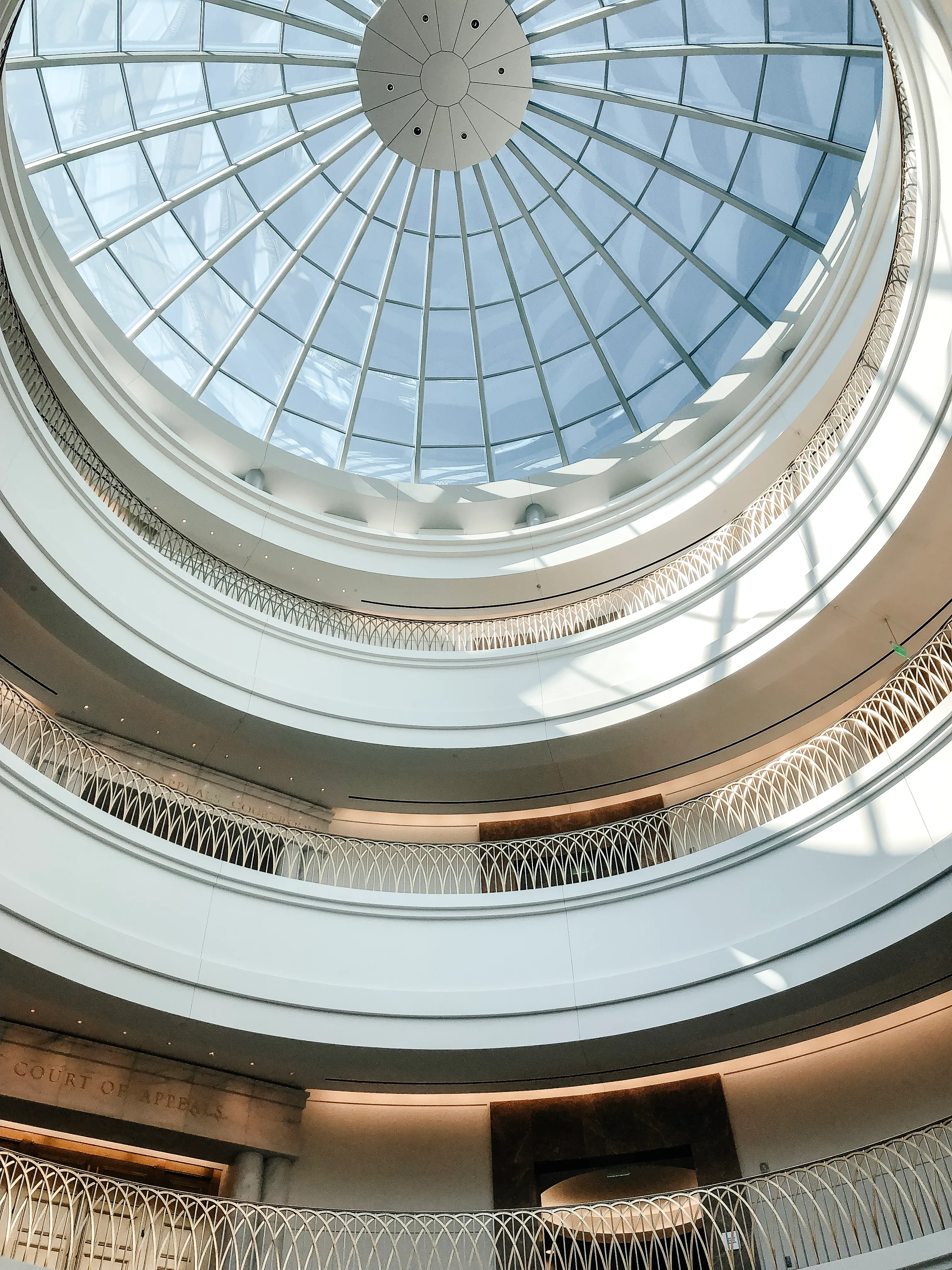 A glass rotunda dome seen from the floor below